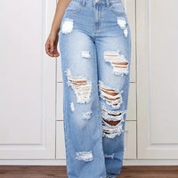 Trendy washed ripped straight jeans for women in light blue denim with distressed patches.