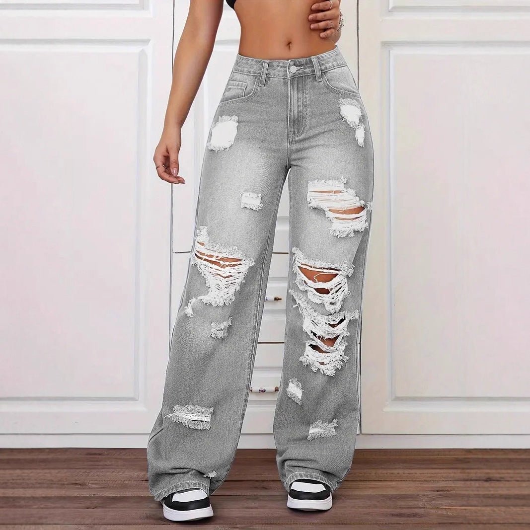 Trendy washed ripped straight jeans for women, grey distressed denim with multiple knee and thigh tears.