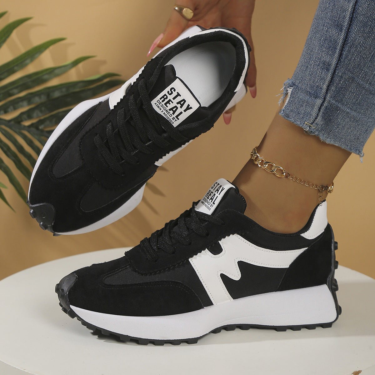 Womens chunky-soled sneakers; black and white lace-up casual shoes by Ancient Energy.