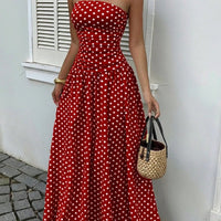 Red polka-dot strapless maxi dress with a fitted bodice and flowing skirt