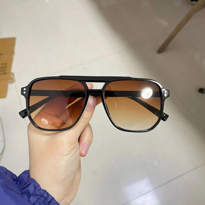 Vintage black square sunglasses for men and women with UV400 protection, designer unisex shades with bold frame and black lenses.