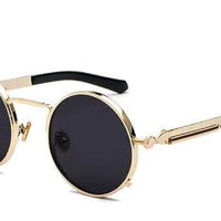 Gold round metal sunglasses with dark lenses, black temple tips, vintage steampunk style.