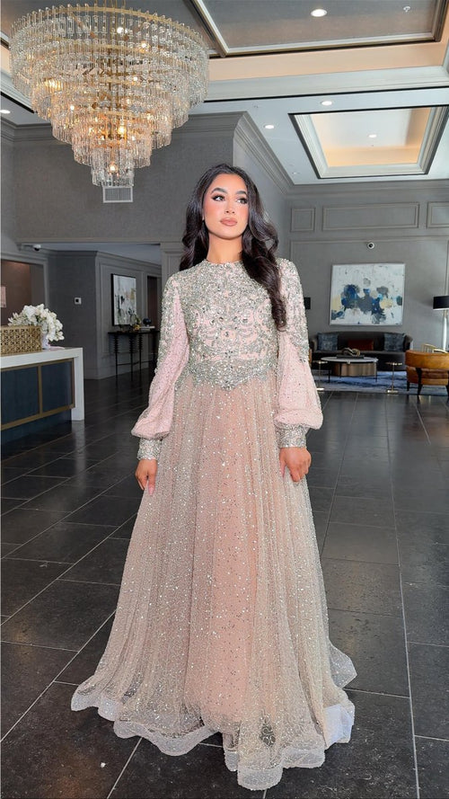 Iyza Belaar Bashira long sleeve embellished sequin modest ball gown, elegant evening dress with intricate detailing and flowing fabric.