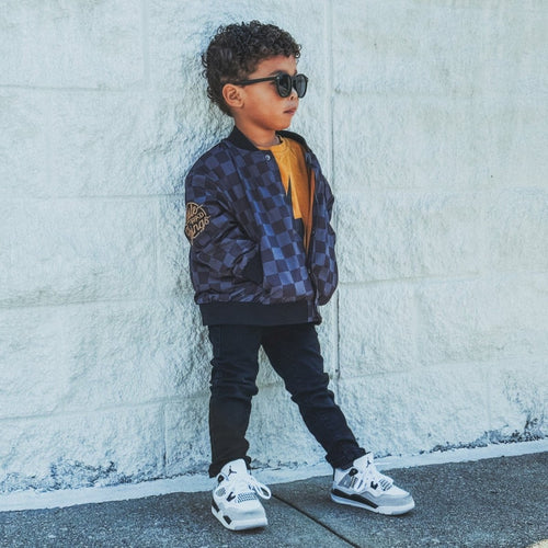 Little Rad Things kids waterproof letterman jacket with checkered pattern, featuring a stylish and durable design for outdoor wear.