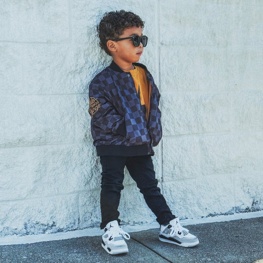 Little Rad Things kids waterproof letterman jacket with checkered pattern, featuring a stylish and durable design for outdoor wear.