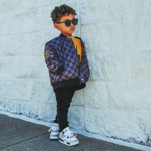 Kids waterproof letterman jacket with checkered pattern by Little Rad Things, featuring a colorful and stylish design for children.