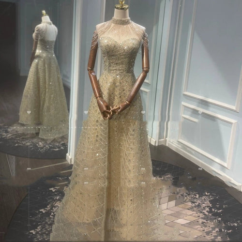 Elegant golden neck hanging light luxury evening dress by MANDOTOS, featuring a sophisticated toast-colored design and intricate details.