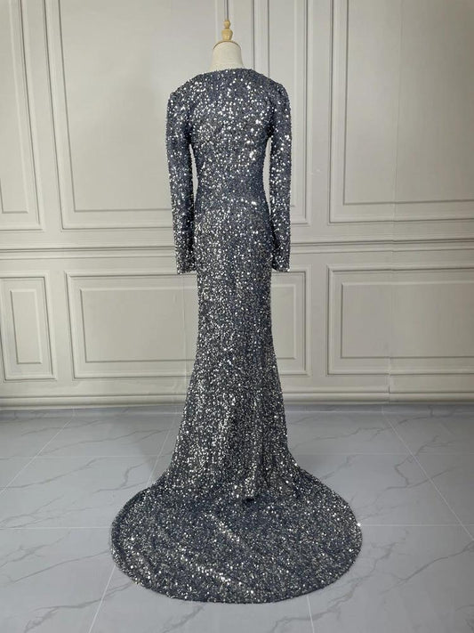 Grey long sleeve sequin evening dress by MANDOTOS, featuring a fitted silhouette and elegant design for formal occasions.