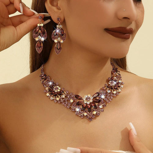 Mandotos crystal necklace and earrings suite featuring high-profile, generous design with sparkling clear crystals.