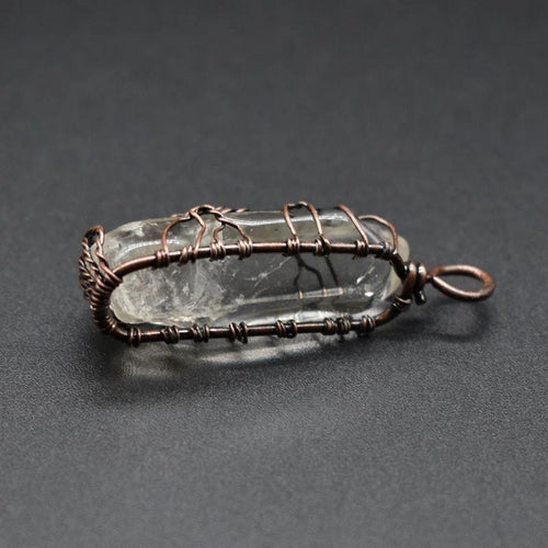 Mandotos stone crystal pillar Tree of Life pendant necklace showcasing intricate design and natural gemstone details.