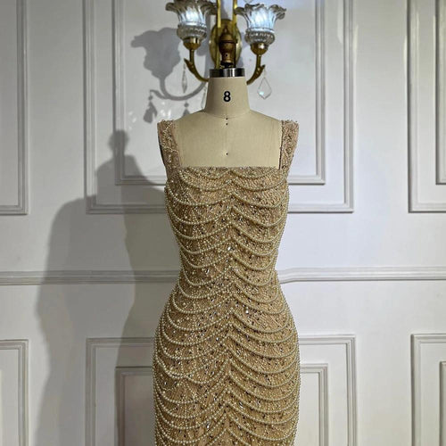 Nude elegant sling dress by MANDOTOS featuring light luxury design with pearl beaded embellishments and high-end style.