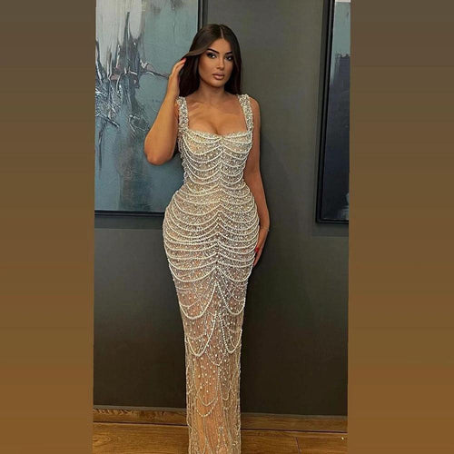 Nude elegant sling dress by MANDOTOS featuring pearl beading, light luxury high-end design, perfect for formal occasions.