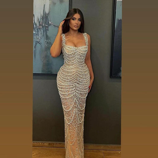 Nude elegant sling dress by MANDOTOS featuring pearl beading, light luxury high-end design, perfect for formal occasions.