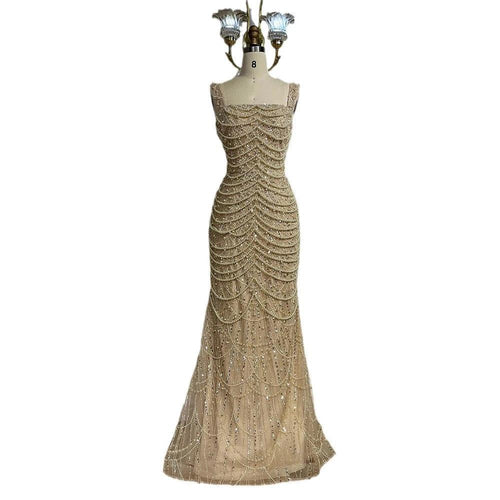 Nude elegant sling dress by MANDOTOS featuring light luxury design with pearl beaded accents and high-end style.
