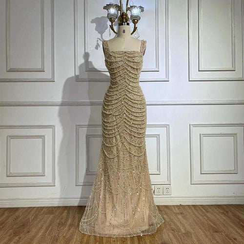 Elegant nude pearl-beaded dress by MANDOTOS featuring a sling style and luxurious high-end design.