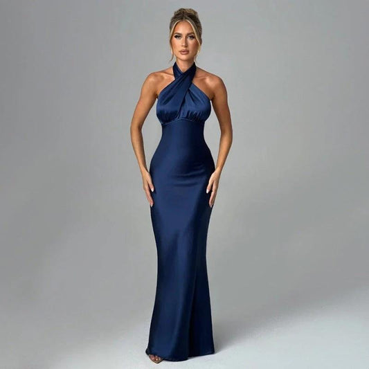Elegant backless sleeveless summer dress by MANDOTOS, featuring a stylish design and flowing fabric for warm weather fashion.