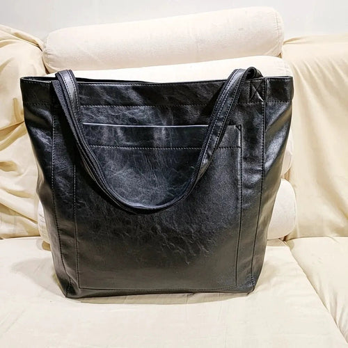 Women's soft leather shoulder bag by MANDOTOS featuring a vintage design and a convenient front pocket.