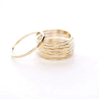 14K gold-filled textured stacking ring from MANDOTOS, showcasing a detailed hammered finish on a slim band.