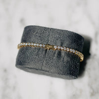 18K gold-plated zircon tennis bracelet by MANDOTOS featuring sparkling cubic zirconia stones and a sleek, elegant design.