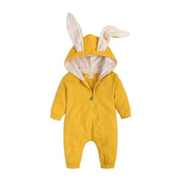 Baby wearing a cute white bunny ear onesie by MANDOTOS, featuring soft fabric and adorable bunny ear hood for cozy comfort.