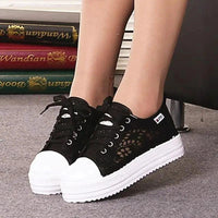 Mandotos women's canvas shoes featuring a casual, stylish design with white laces and a comfortable flat sole.