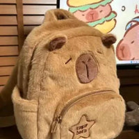 Mandotos Capybara Cuddle Backpack featuring a soft plush design and realistic capybara face for cute, cozy carrying.