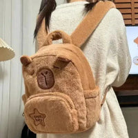 Mandotos Capybara Cuddle Backpack featuring a soft, plush capybara design with adjustable straps and cute facial details.