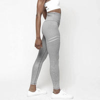 Mandotos chic gold print leggings with stylish pattern, close-up view of the vibrant gold design on black fabric.
