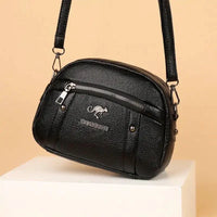 Mandotos chic leather circle purse with a sleek design, featuring a smooth brown leather finish and a compact, stylish shape.