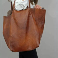 Mandotos chic leather tote handbag with sturdy handles and spacious interior, ideal for daily use and stylish accessorizing.