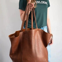Mandotos chic leather tote handbag with sturdy handles and spacious interior, stylish accessory for everyday use.