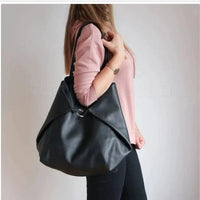 Mandotos chic leather tote handbag with sturdy handles and sleek design, perfect for everyday use and stylish occasions.
