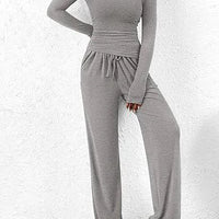 Mandotos chic long-sleeve trousers set featuring a stylish top and matching trousers in a modern, elegant design.