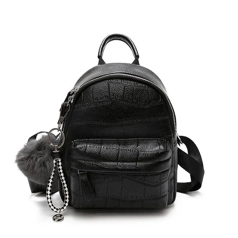 Mandotos chic mini leather backpack with top handle and adjustable shoulder straps, featuring a sleek design and compact size.