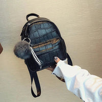 Mandotos Chic Mini Leather Backpack with adjustable straps and gold-tone hardware, perfect for casual or stylish outings.