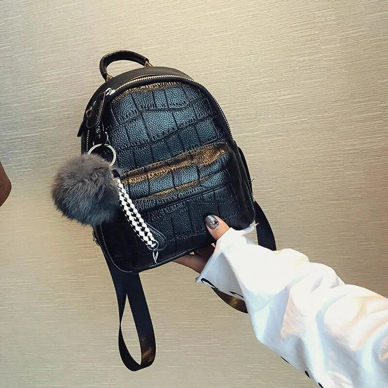 Mandotos Chic Mini Leather Backpack with adjustable straps and gold-tone hardware, perfect for casual or stylish outings.