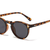 Mandotos chic round UV-block sunglasses with black frames and dark lenses, stylish and protective for outdoor wear.