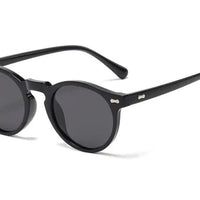 Mandotos chic round UV-block sunglasses with black frames and dark lenses, stylish and protective for sunny days.