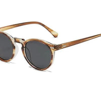 Mandotos chic round UV-block sunglasses with black frames and dark lenses, stylish and protective for sunny days.