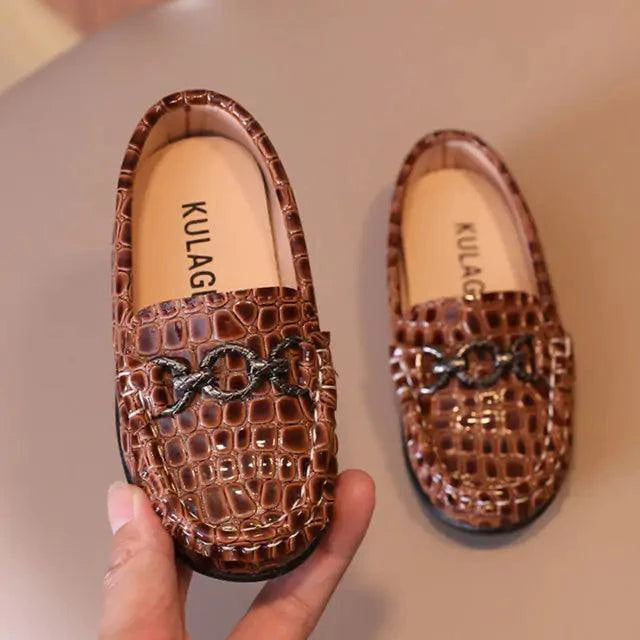 Toddler wearing stylish leather sneakers from MANDOTOS, featuring a chic design and comfortable fit.