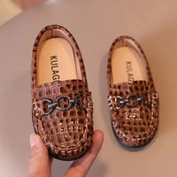 Toddler wearing stylish leather kicks from MANDOTOS, showcasing the chic design and comfortable fit of the shoes.
