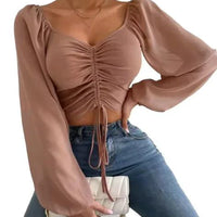 Mandotos chic V-neck balloon sleeve crop top displayed on a model, featuring stylish design and trendy silhouette.