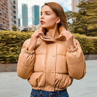 Mandotos chic winter PU leather jacket displayed on a hanger, featuring a stylish design and smooth black leather texture.