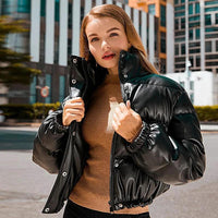 Mandotos chic winter PU leather jacket displayed on a hanger, showcasing a stylish, fitted design with a smooth, matte finish.