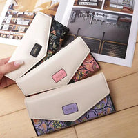 Mandotos chic women's leather clutch wallet and card holder with sleek design and compact storage for cards and cash.