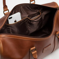 Mandotos classic leather duffel bag with sturdy handles and spacious interior, ideal for travel and weekend trips.