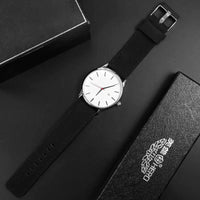 Mandotos classic leather timepiece with a black leather strap and round silver watch face showing time and minimalist design.
