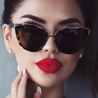 Mandotos Cleo Cat Eye Shades with black frames and tinted lenses, stylish eyewear for a chic, vintage-inspired look.