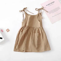Toddler girl wearing a light cotton sundress with ruffled straps and floral pattern, by MANDOTOS.