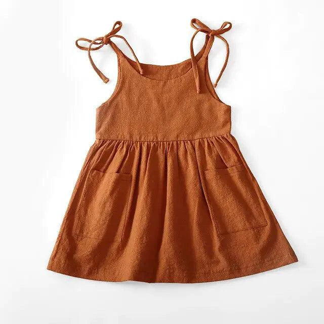 Toddler girl wearing a Cotton Chic Sundress by MANDOTOS, featuring lightweight cotton fabric and a stylish, comfortable design.